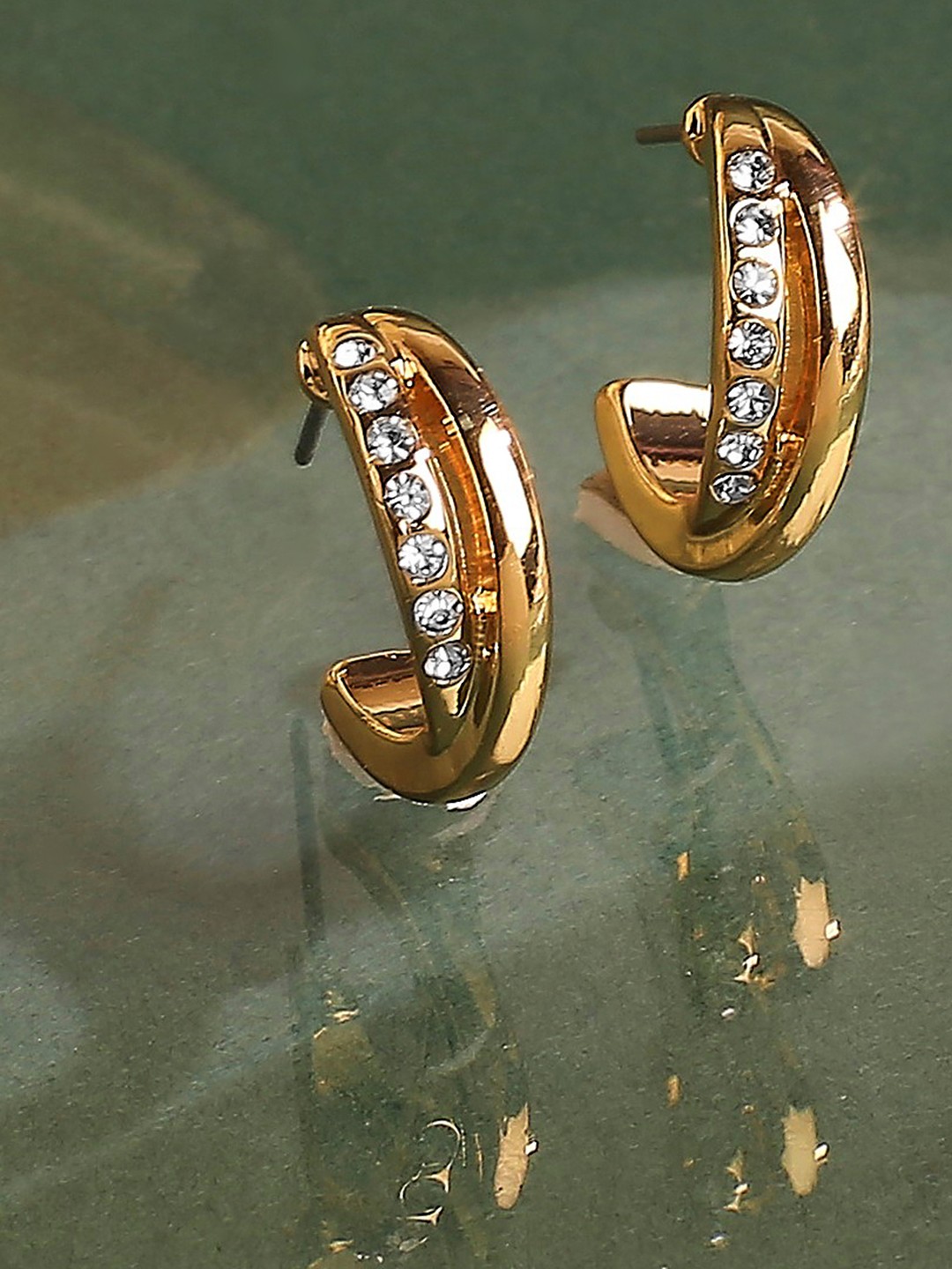 Gold toned crystal studded half hoop earrings
