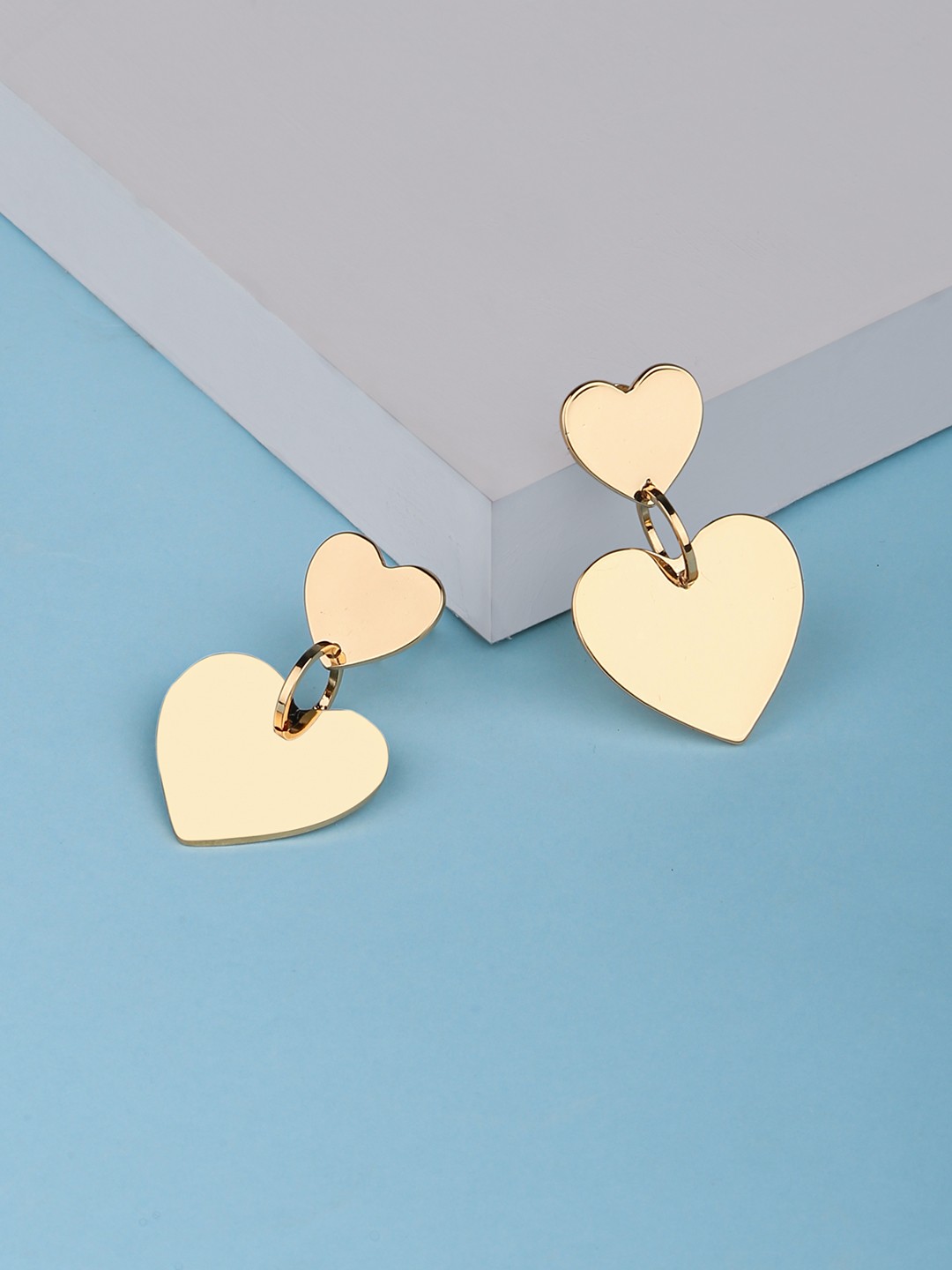 Gold toned twin heart shaped dangler earrings