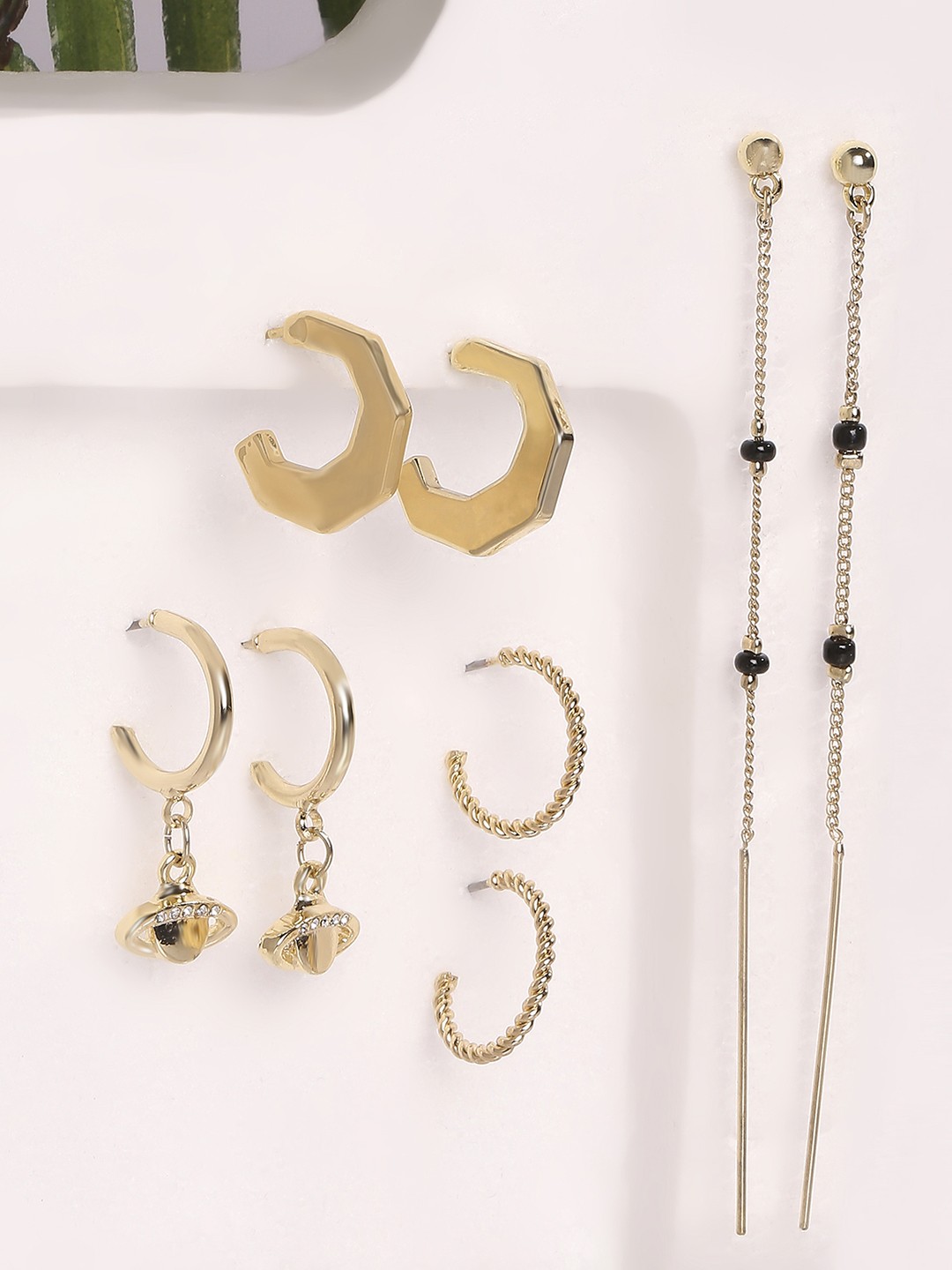 Set of 4 gold toned 3 hoops and 1 long chain dangler earrings