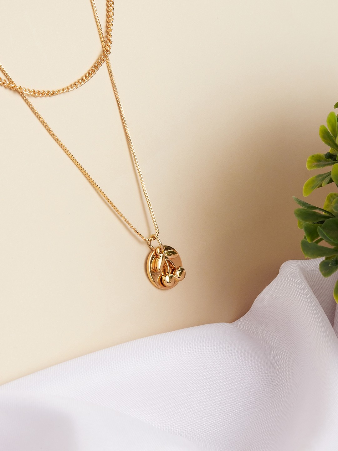Gold toned two layered necklace with cherry & coin pendant