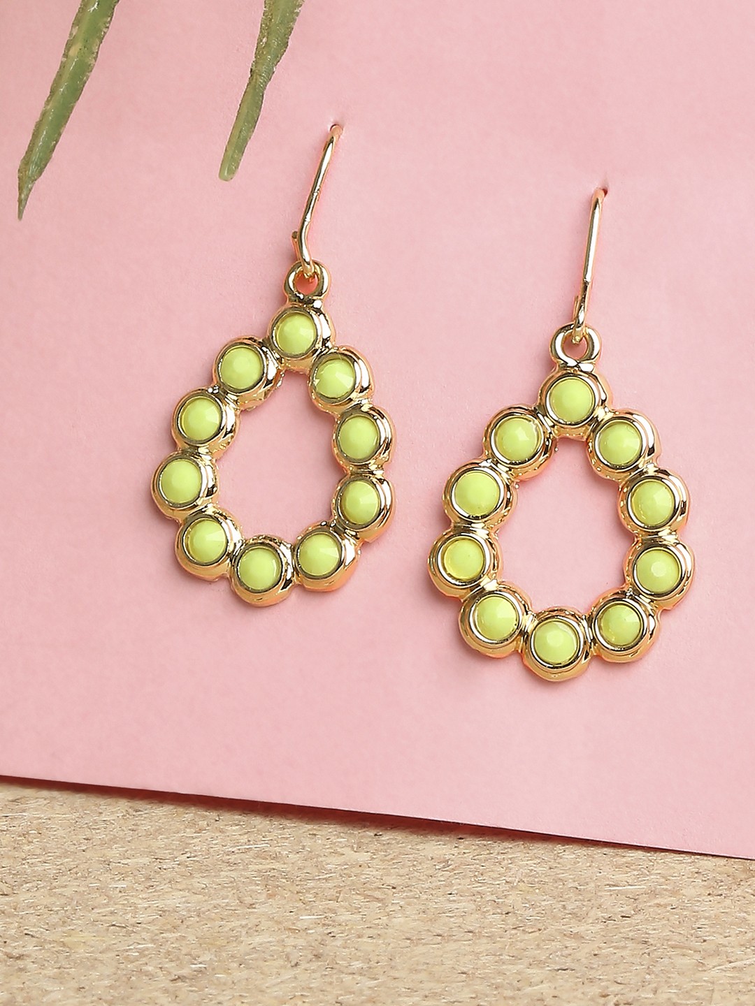 Gold toned drop earrings with green stones