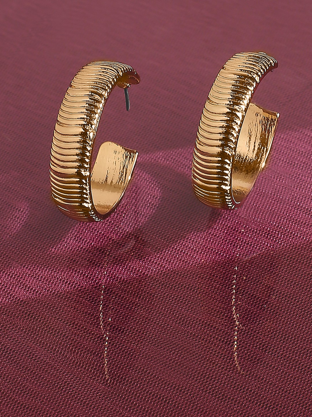 Gold toned thick wave texured hoop earrings
