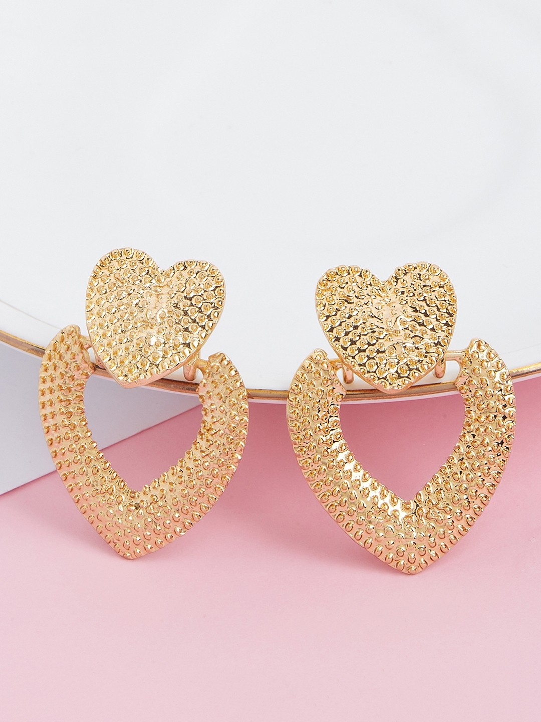 Gold toned heart shaped embossed stud earrings