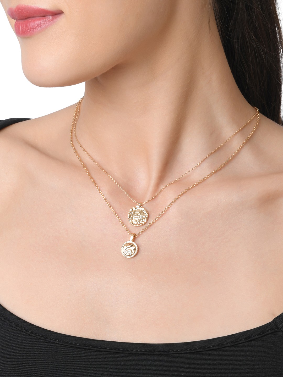Gold toned two layered necklace with textured coin charm