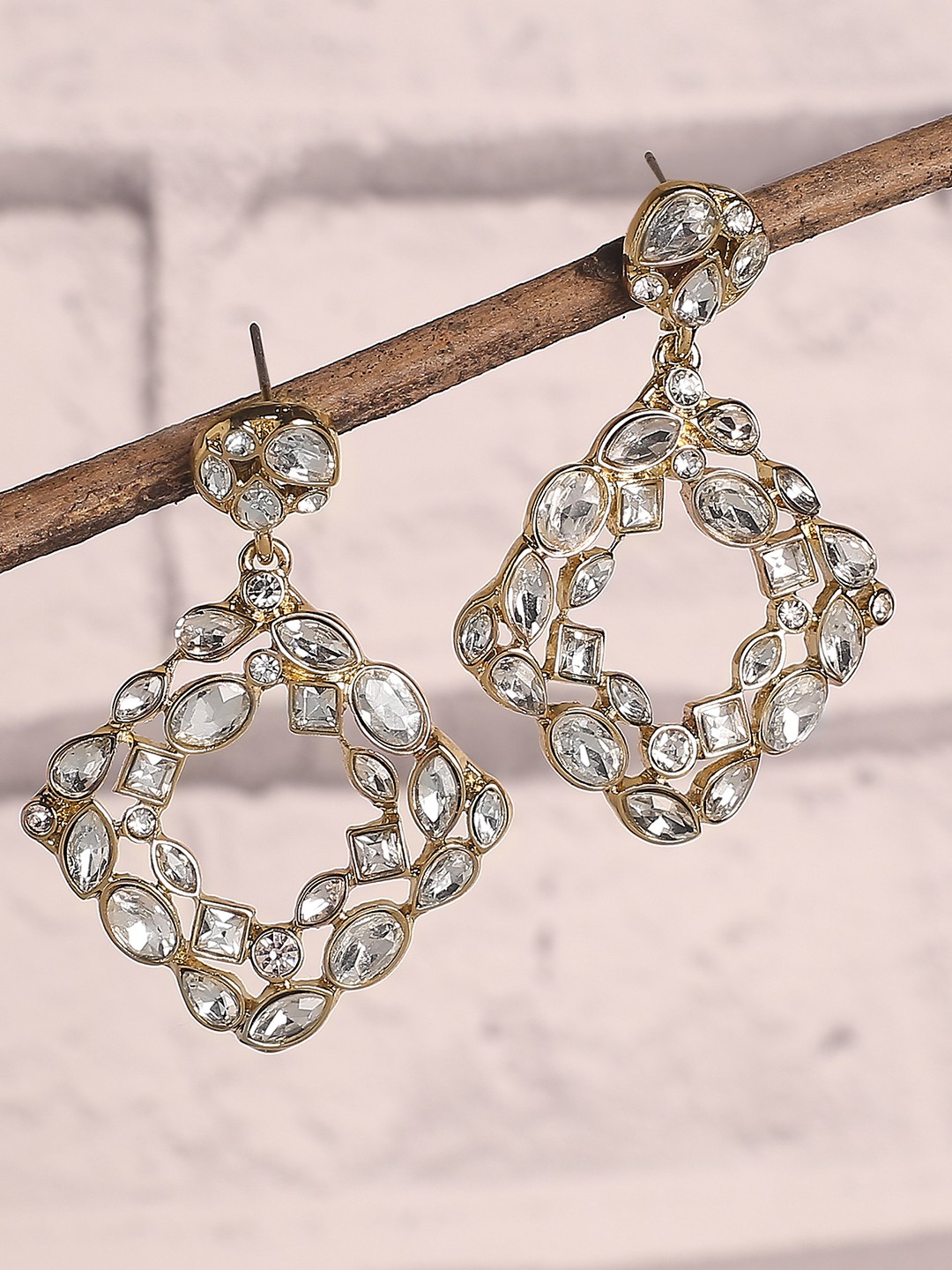 Gold toned geometric dangler earrings with stone