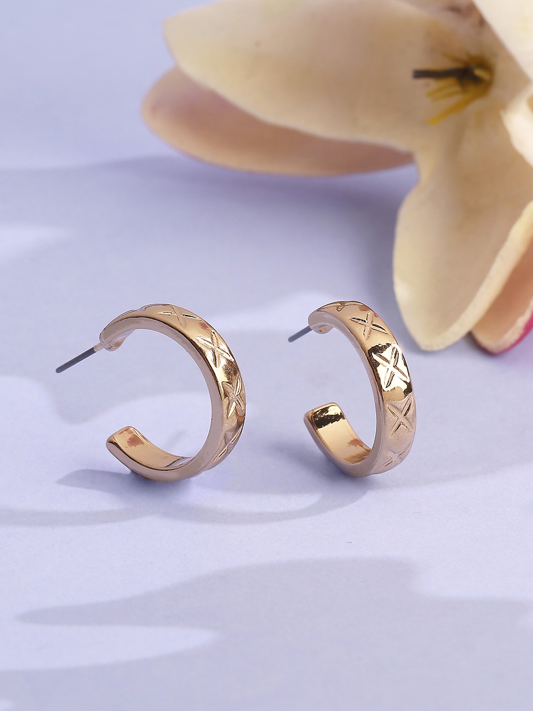 Gold toned textured half hoop earrings
