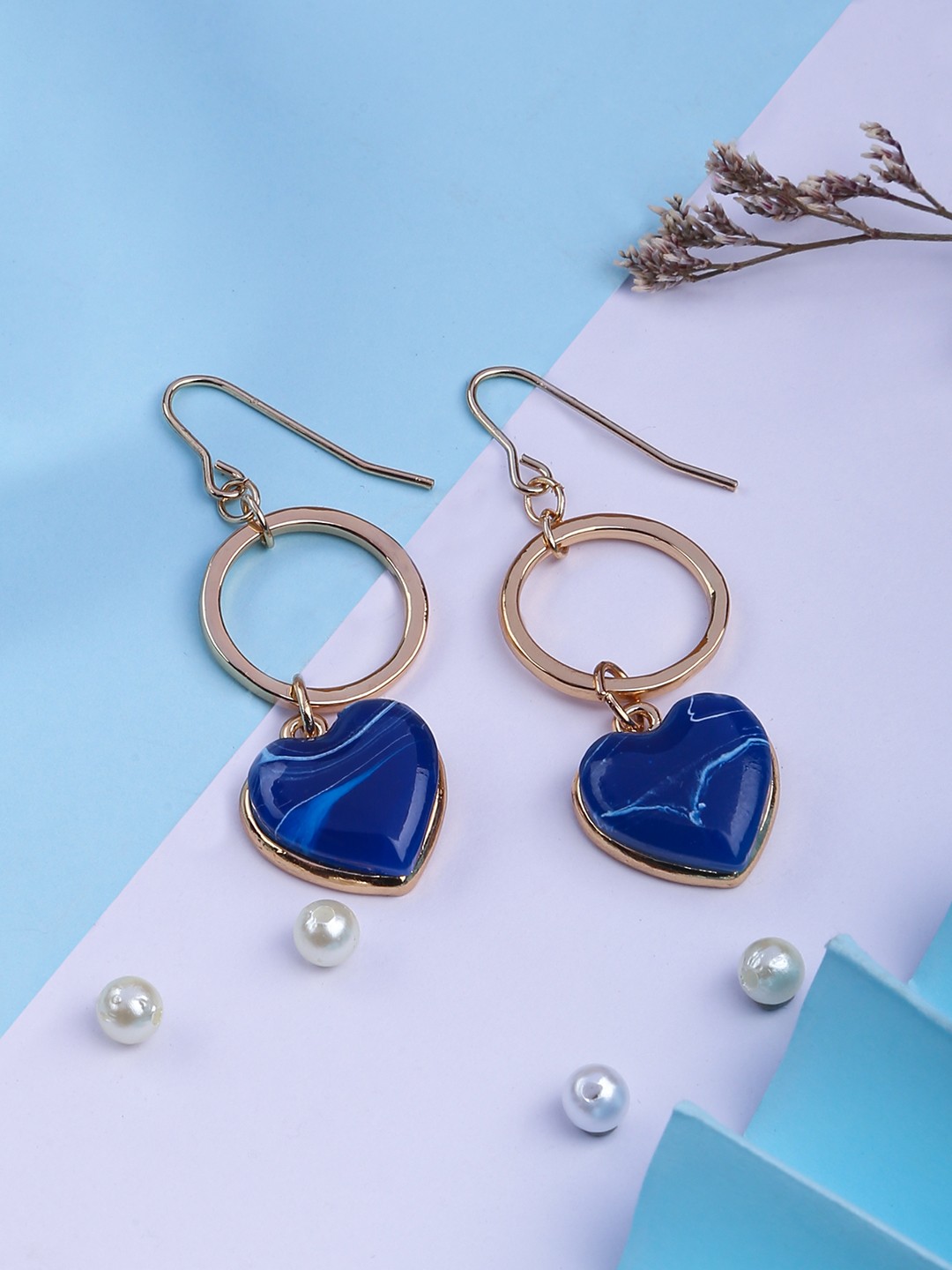 Gold toned drop earrings with blue enameled heart charm