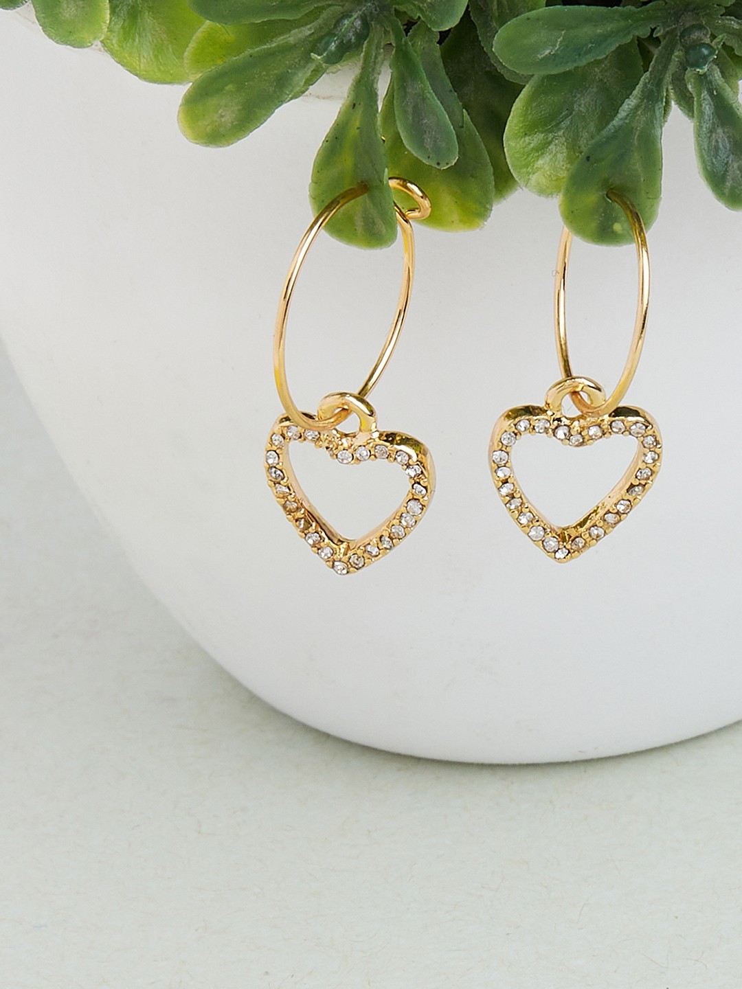 Gold toned hoop earrings with crystal studded drop heart