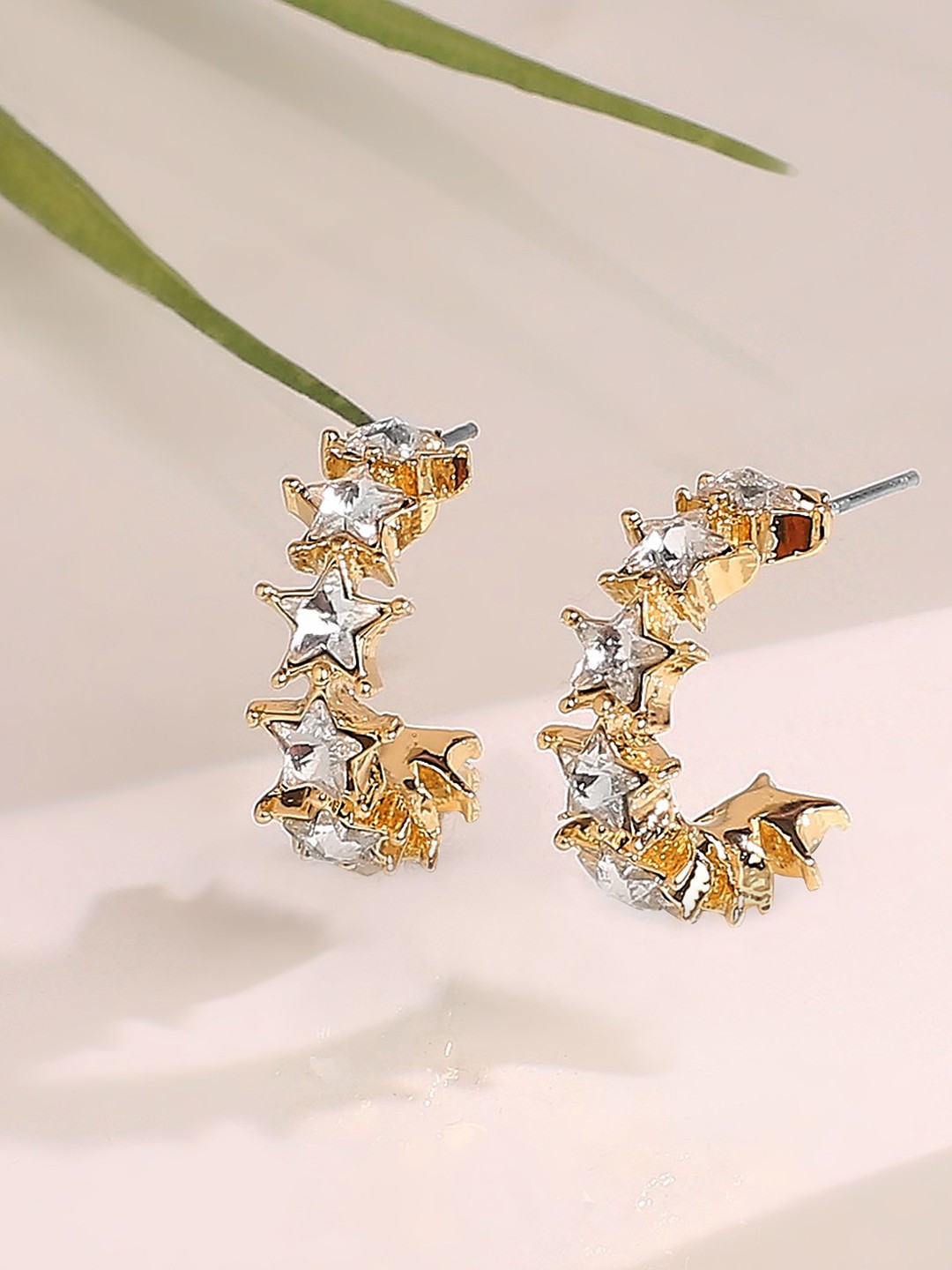 Gold toned star stone half hoop earrings